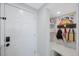 Functional mudroom with built-in bench, storage shelves and wall hooks for organizing coats, bags and accessories at 14950 Gulf Blvd # 902, Madeira Beach, FL 33708