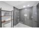 Contemporary tiled shower with glass door and shelf unit at 14950 Gulf Blvd # 902, Madeira Beach, FL 33708