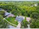 Aerial view of home with lush green landscaping, pool, and shed at 15108 Winterwind Dr, Tampa, FL 33624