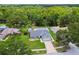 Charming single-story home featuring lush landscaping, a brick driveway and an attached two-car garage at 15108 Winterwind Dr, Tampa, FL 33624