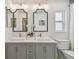 Bathroom boasts double sinks, modern fixtures, framed mirrors, and a window letting in natural light at 15108 Winterwind Dr, Tampa, FL 33624
