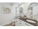 Elegant bathroom with double vanity, granite countertop, modern fixtures, and decorative mirrors at 15108 Winterwind Dr, Tampa, FL 33624