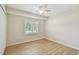 The bedroom has wood-look tile floors and a window providing ample natural light at 15108 Winterwind Dr, Tampa, FL 33624