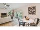 Bright dining area with modern table, chairs, and view of the living room and outdoor patio at 15108 Winterwind Dr, Tampa, FL 33624
