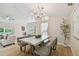 Open dining area with a modern table set, decorative chandelier, and seamless access to living spaces at 15108 Winterwind Dr, Tampa, FL 33624
