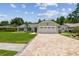 Lovely single-story house featuring a lush green lawn, a paved driveway, and an attached two-car garage at 15108 Winterwind Dr, Tampa, FL 33624