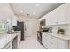 Clean kitchen with white cabinetry, stainless steel appliances, and tiled backsplash at 15108 Winterwind Dr, Tampa, FL 33624