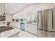 Bright kitchen featuring modern appliances, white cabinets, and ample countertop space at 15108 Winterwind Dr, Tampa, FL 33624