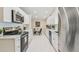 A modern kitchen featuring white cabinets, stainless steel appliances, and ample counter space at 15108 Winterwind Dr, Tampa, FL 33624