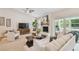 Comfortable living room with a brick fireplace, large windows, and neutral tones at 15108 Winterwind Dr, Tampa, FL 33624