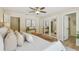 Spacious main bedroom with ceiling fan, a comfortable bed, and large closet with sliding mirror doors at 15108 Winterwind Dr, Tampa, FL 33624