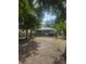Backyard featuring a detached house, trees, and partial fence at 159 6Th Nw St, Largo, FL 33770
