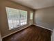 Cozy bedroom featuring neutral colors, ample natural light, and wood-look flooring at 159 6Th Nw St, Largo, FL 33770