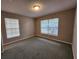 Bedroom with neutral carpet, paint, and natural light from two windows at 159 6Th Nw St, Largo, FL 33770