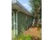 Side exterior showcasing green painted siding with white trim at 159 6Th Nw St, Largo, FL 33770