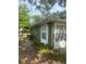 Side exterior view of the house with green paint and white trim at 159 6Th Nw St, Largo, FL 33770