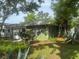 Charming exterior of the single-story home with lots of large trees and greenery at 159 6Th Nw St, Largo, FL 33770