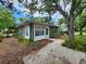 Green home exterior featuring a walkway, white trim, and lush landscaping at 159 6Th Nw St, Largo, FL 33770
