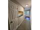 Hallway with carpet, storage, and view to the front door at 159 6Th Nw St, Largo, FL 33770