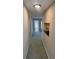 Hallway featuring carpet, gray paint, and an in-wall shelf at 159 6Th Nw St, Largo, FL 33770