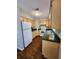 Bright kitchen with wood cabinets, laminate counters, and white appliances at 159 6Th Nw St, Largo, FL 33770