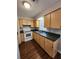 Functional kitchen with wooden cabinets, laminate countertops, and hardwood floor at 159 6Th Nw St, Largo, FL 33770
