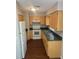 Traditional kitchen featuring wood cabinets, green countertops, and white appliances at 159 6Th Nw St, Largo, FL 33770