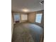 Bright living room with neutral walls, carpet, and good natural lighting at 159 6Th Nw St, Largo, FL 33770