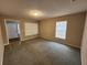 Spacious carpeted living room with natural light from two windows at 159 6Th Nw St, Largo, FL 33770