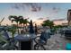 Beautiful waterfront backyard with a pool, patio, and dock for boats, perfect for outdoor entertaining at sunset at 16106 6Th E St, Redington Beach, FL 33708