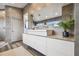 Modern bathroom featuring a floating vanity, dual sinks, granite countertops, and views of the canal at 16106 6Th E St, Redington Beach, FL 33708