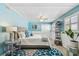 Bright bedroom featuring a seaside aesthetic, light blue walls, and plantation shutters at 16106 6Th E St, Redington Beach, FL 33708