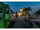 Waterfront property with modern home, dock, outdoor seating, and lush landscaping for relaxing evenings at 16106 6Th E St, Redington Beach, FL 33708