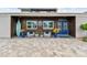 Charming entrance featuring comfortable seating, rustic wood accents, and a beautifully paved driveway at 16106 6Th E St, Redington Beach, FL 33708