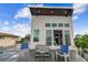 Stylish home exterior with outdoor seating and a balcony overlooking the surrounding area at 16106 6Th E St, Redington Beach, FL 33708
