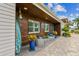 Inviting front entrance showcasing outdoor seating, beautiful plants, and unique architectural details at 16106 6Th E St, Redington Beach, FL 33708