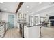 Spacious kitchen with modern appliances, a large island, and an open layout leading to the dining area at 16106 6Th E St, Redington Beach, FL 33708