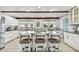 Bright, expansive kitchen with white cabinetry, an island with seating, and stainless steel appliances at 16106 6Th E St, Redington Beach, FL 33708