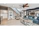 Open-concept living room featuring a staircase, built-in shelving, and ample seating at 16106 6Th E St, Redington Beach, FL 33708