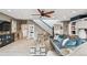 Open-concept living area featuring hardwood floors, staircase, and comfortable seating at 16106 6Th E St, Redington Beach, FL 33708