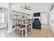 Open-concept living room featuring bar-height seating, shiplap walls, and a cozy fireplace at 16106 6Th E St, Redington Beach, FL 33708