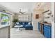 Cozy living room with comfortable sofa, bar area, and views of the outdoors at 16106 6Th E St, Redington Beach, FL 33708