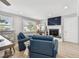 Cozy living room featuring comfortable seating, a fireplace, and bright natural light at 16106 6Th E St, Redington Beach, FL 33708