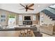 Cozy living room featuring a large TV, comfortable seating, and access to the outdoor area at 16106 6Th E St, Redington Beach, FL 33708