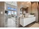 Modern main bathroom featuring double vanity, neutral tile, with expansive views at 16106 6Th E St, Redington Beach, FL 33708
