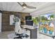 Modern home office with views, textured ceiling, and a stylish desk setup at 16106 6Th E St, Redington Beach, FL 33708