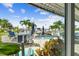 This covered patio overlooks a swimming pool, canal, boat dock and lift, perfect for Florida living at 16106 6Th E St, Redington Beach, FL 33708