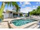 Backyard pool area with lounge seating, dining table, lush foliage, and attractive outdoor living space at 16106 6Th E St, Redington Beach, FL 33708