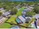 Aerial view of a home with a screened-in pool and lush landscaping in a quiet, tree-lined neighborhood at 1910 Montego Ct, Oldsmar, FL 34677