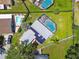 Aerial view of a home with solar panels, backyard pool and sitting area at 1910 Montego Ct, Oldsmar, FL 34677